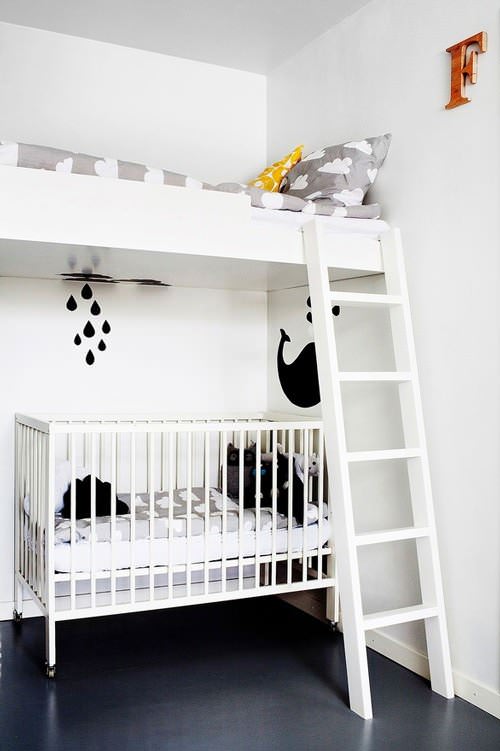 Bunk bed over a crib in a kid's room
