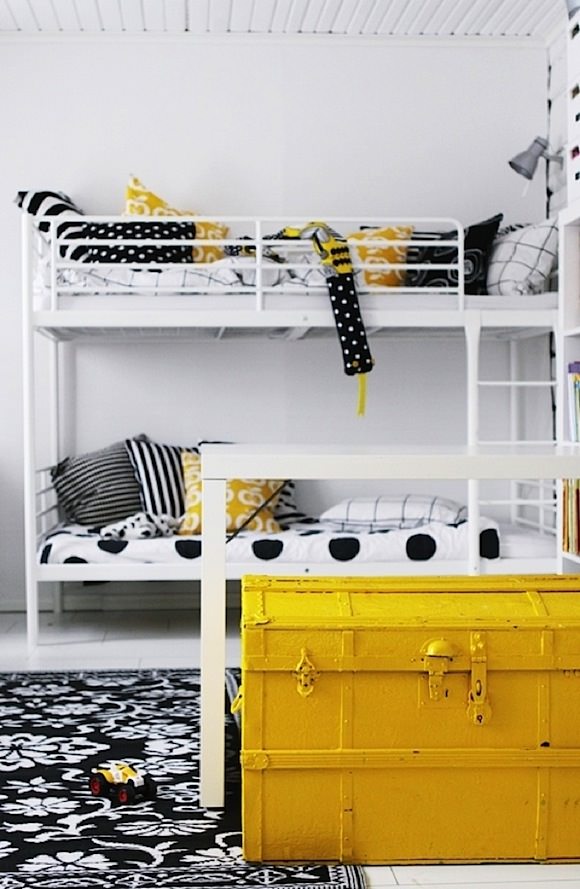 yellow painted military trunk add a pop of color in a child's room