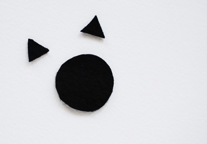 Create wooden critter ornaments with a wooden ball and black felt